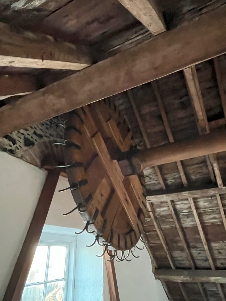 Gracehill Old Shop Restored winch wheel in the attic store.